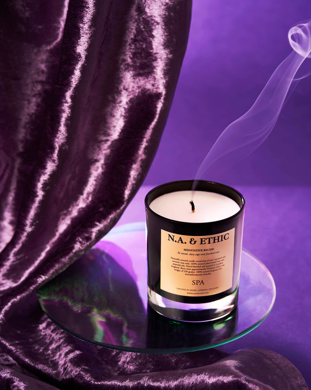 Luxury natural aromatherapy essential oil scented candle, handmade from biodegradable plant based rapeseed and coconut wax and pure essential oils. Candle perfect for meditation and relaxation. Used for spa massage and improving wellbeing. Hand-poured in the UK. Toxin free. Premium black glossy glass jar. 